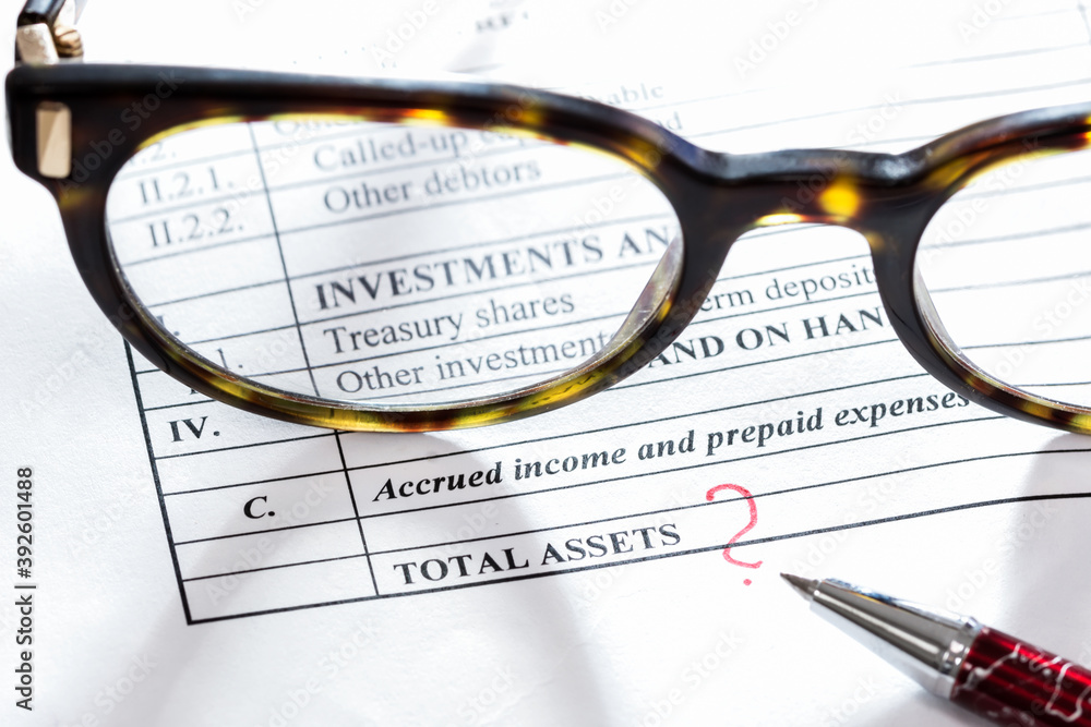 Balance sheet item “Investments and term deposits” through person eyeglasses and pen close it on a table, finance, banking and accountancy concept Balance sheet item “Investments and term deposits” through person eyeglasses and pen close it on a table, finance, banking and accountancy concept