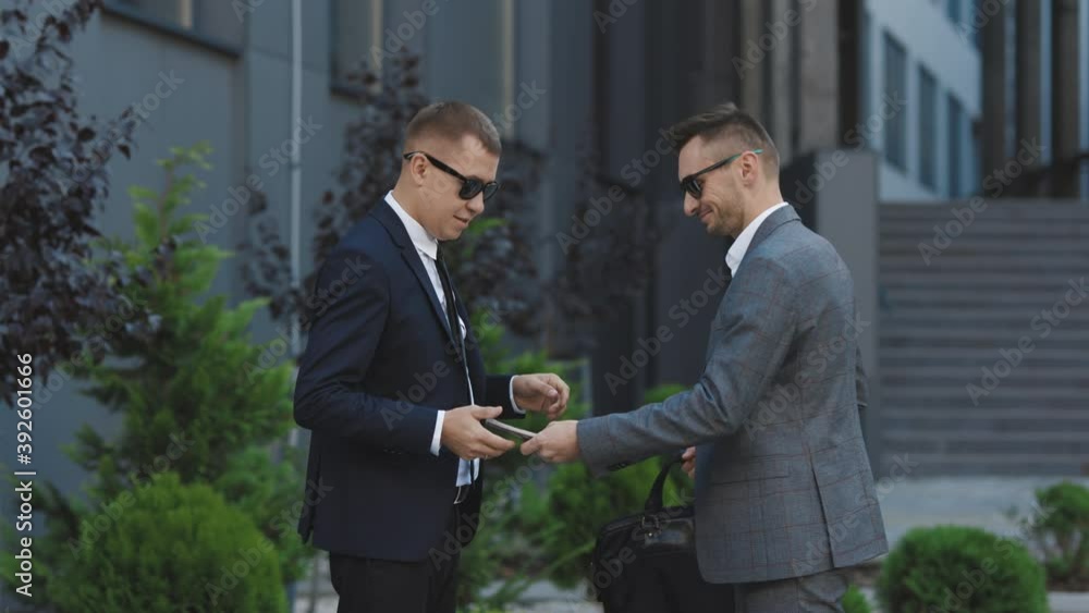 Two unrecognized business partners shaking hands. Colleagues just made good deal. Business relationship. Successfully made deal. Handshake - business people shaking hands Two unrecognized business partners shaking hands. Colleagues just made good deal. Business relationship. Successfully made deal. Handshake - business people shaking hands