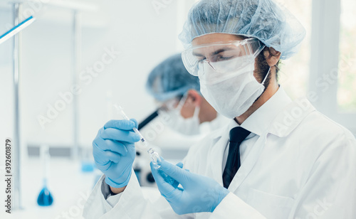 background image of a laboratory assistant in a medical laboratory