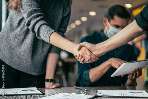 young people shaking hands in the office.