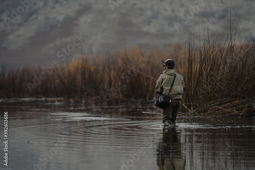 portrait of fisherman in the lake at sunset