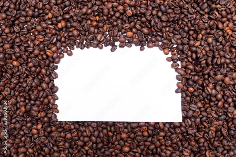 Pile of fresh aromatic coffee beans and paper mockup cup. Place for text or logo. Copy space. Pile of fresh aromatic coffee beans and paper mockup cup. Place for text or logo. Copy space.