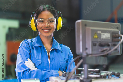 portrait asian female Professional engineering wearing uniform and safety goggles Quality control, maintenance, check in factory, warehouse Workshop for factory operators