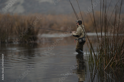 portrait of fisherman in the lake at sunset