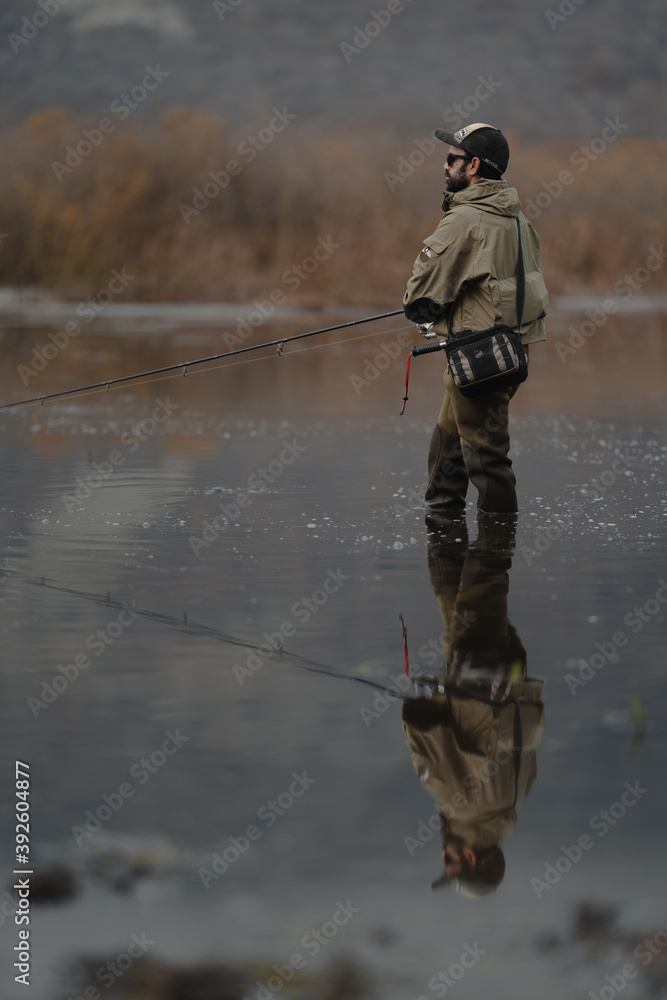 portrait of fisherman in the lake at sunset portrait of fisherman in the lake at sunset