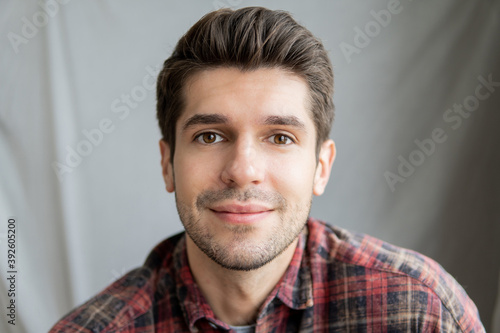 Portrait of a handsome latin guy with a cute face expression looking in to the camera isolated 