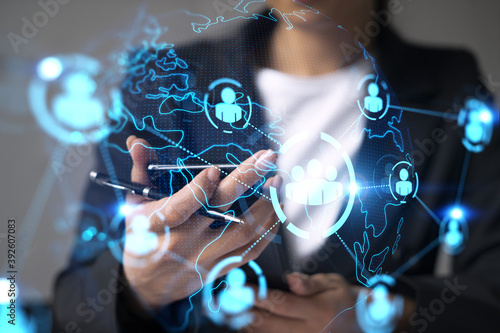 Businesswoman using smart phone in office. Social media icon hologram. Business network concept. Double exposure.