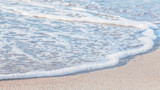 the waves of the sea on the sandy beach on a sunny day