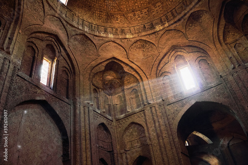 Interior of ancient Jameh (Jame, Masjid) Mosque with rays of light from the window in Esfahan, Iran. It has been a UNESCO World Heritage Site since 2012 photo