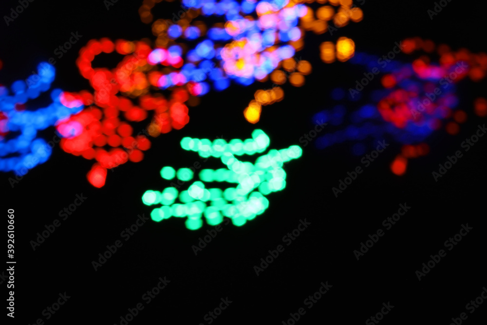 abstract circle line blue and green and orange urban realistic blurred glitter light colorful texture on black.