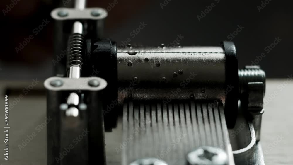 Music box mechanism rotates close-up on white background. Insides of music box during work. worm-gear. Music box mechanism rotates close-up on white background. Insides of music box during work. worm-gear.