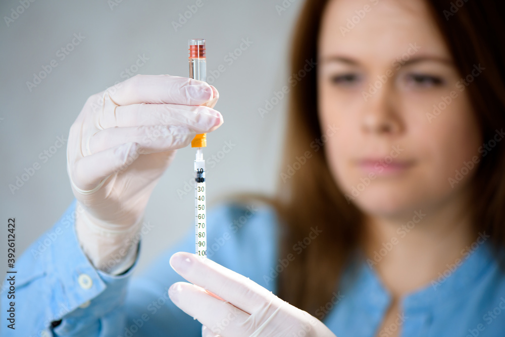 A girl fills a syringe for insulin injections. Diabetes. The short-acting insulin. Insulin injection at home. A girl fills a syringe for insulin injections. Diabetes. The short-acting insulin. Insulin injection at home.
