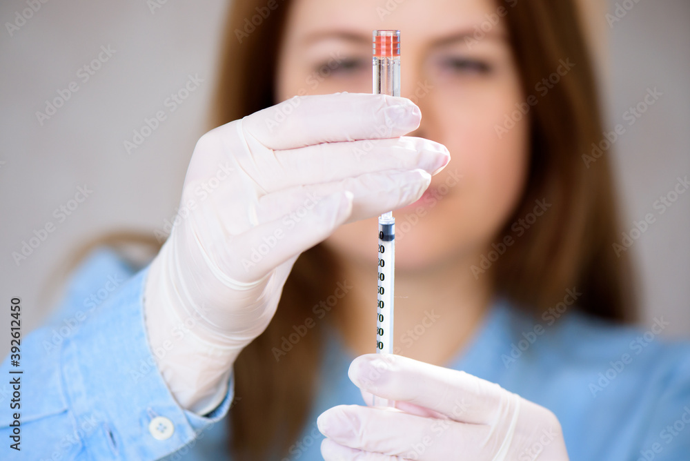 Docto fills a syringe for insulin injections. Diabetes. The shortacting insulin. Insulin injection Docto fills a syringe for insulin injections. Diabetes. The shortacting insulin. Insulin injection