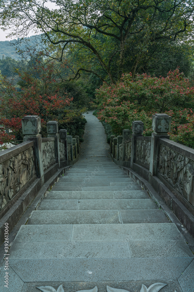 A Chinese stone bridge at the lakeside of West lake in Hangzhou, China, autumn time.