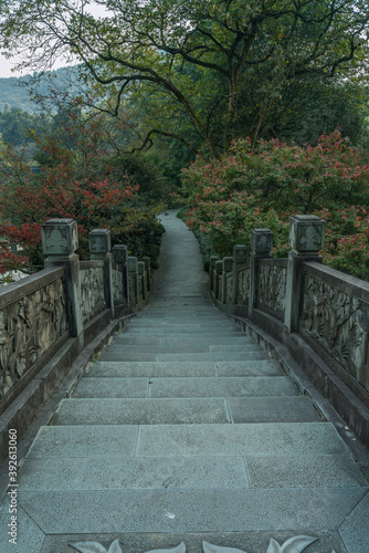 A Chinese stone bridge at the lakeside of West lake in Hangzhou  China  autumn time.