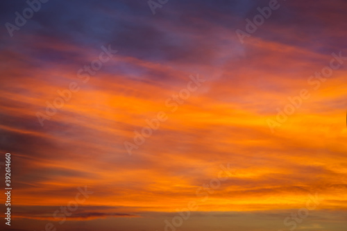 Sky sunset in the evening with colorful orange sunlight. Beautiful majestic nature background © es0lex