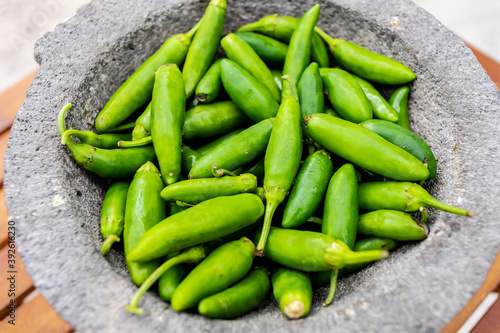 Set of green peppers in mortar