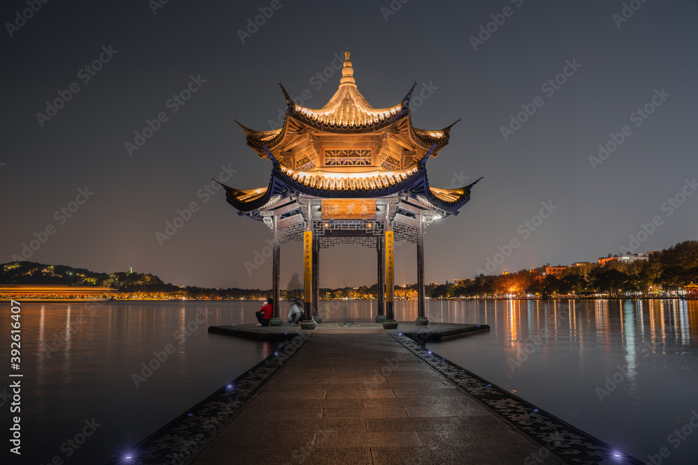 Night view of Jixian pavilion, the landmark at the West Lake in Hangzhou, China.