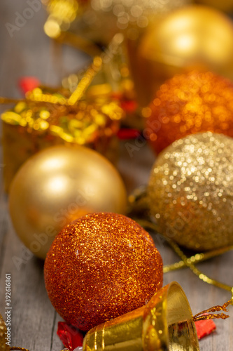 Merry Christmas and Happy New Year background with golden colored glitter Xmas baubles