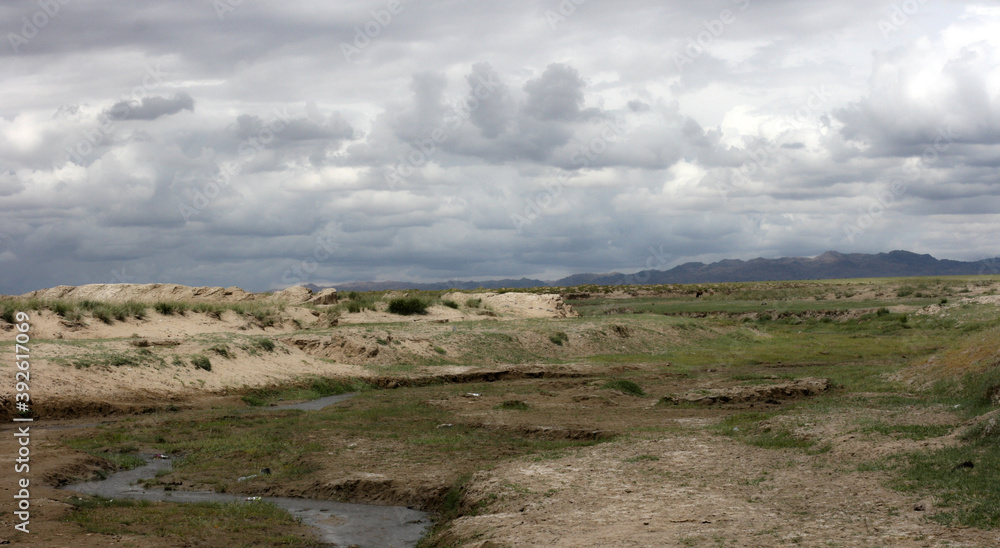 Landscapes of Mongolia. Desert mountain slopes and valleys. Mountain mountain range on the background of the steppe. Photo with copy space. Landscapes of Mongolia. Desert mountain slopes and valleys. Mountain mountain range on the background of the steppe. Photo with copy space.
