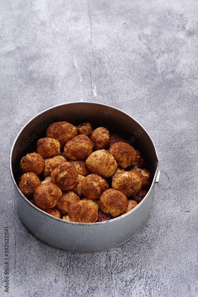 Grainy texture of Monkey bread or Cinnamon pull apart bread in a circle cake mold. Isolated grainy texture gray background with a Mint leaf Grainy texture of Monkey bread or Cinnamon pull apart bread in a circle cake mold. Isolated grainy texture gray background with a Mint leaf