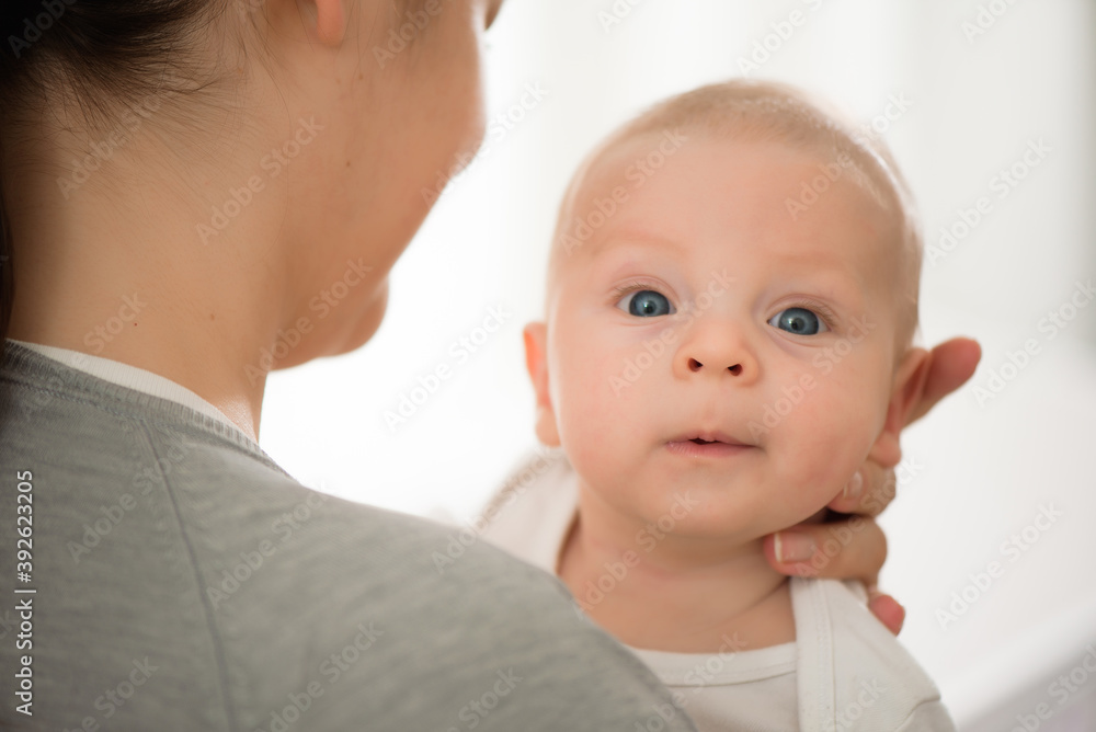 Portrait of happy mother and baby, parent and little kid relaxing at home. Family having fun together. Portrait of happy mother and baby, parent and little kid relaxing at home. Family having fun together.
