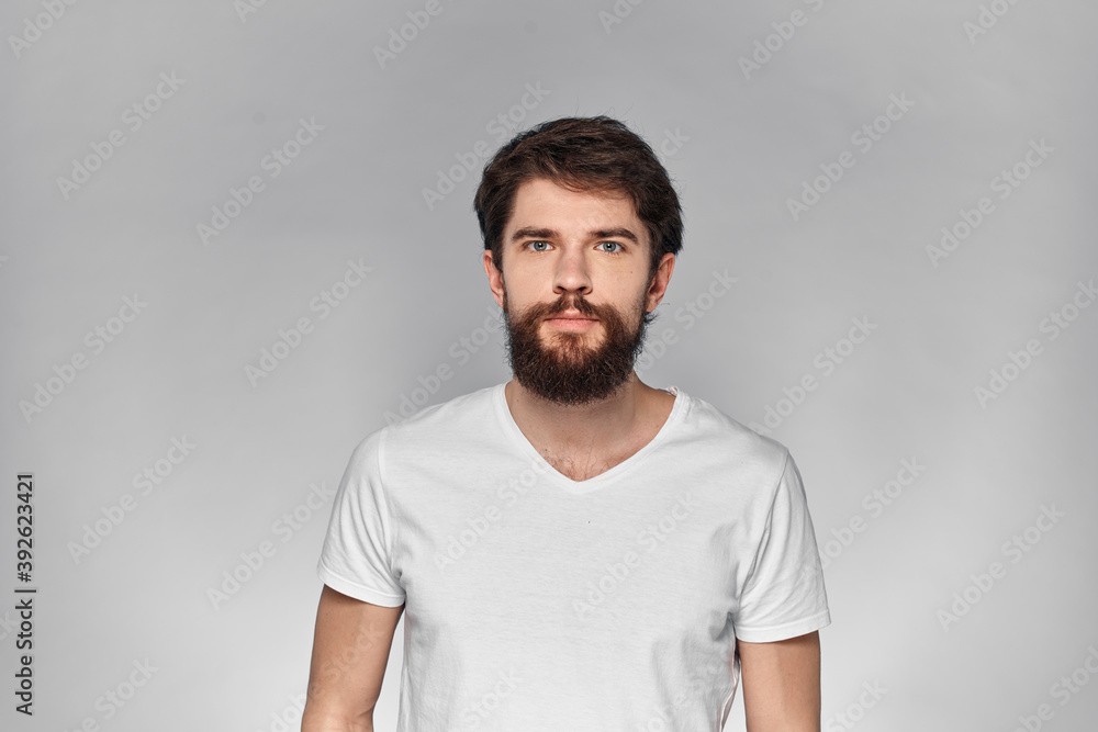 cheerful emotional bearded man gesturing with his hands close-up light background cheerful emotional bearded man gesturing with his hands close-up light background