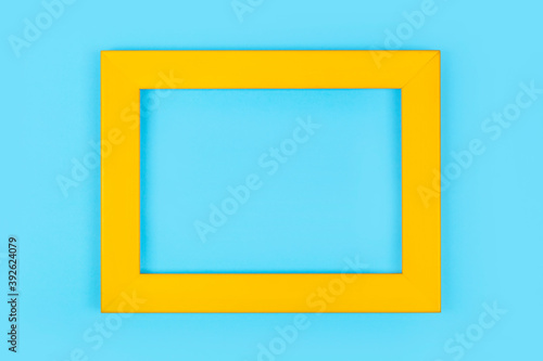 Simple yellow frame on pastel blue background,minimal border composition
