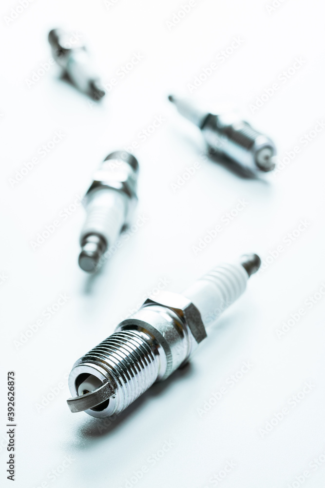 Car engine. Set of new metal car part. Auto spark plugs or automotive piece isolated on white background. Automobile engine service. Car engine. Set of new metal car part. Auto spark plugs or automotive piece isolated on white background. Automobile engine service.