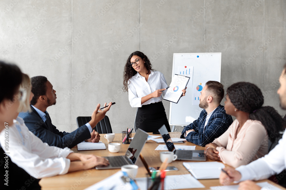 Latin Businesswoman Making Business Presentation For Colleagues In Modern Office Latin Businesswoman Making Business Presentation For Colleagues In Modern Office