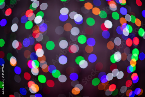 beautiful colored bokeh festive background consisting of multicolored lights out of focus on dark background