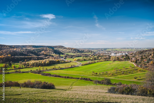 Panoramic view from the Schumisberg, a hill near the city of Leonberg, Germany. Fresh fields, a curvy country road and forested hills are in the background.