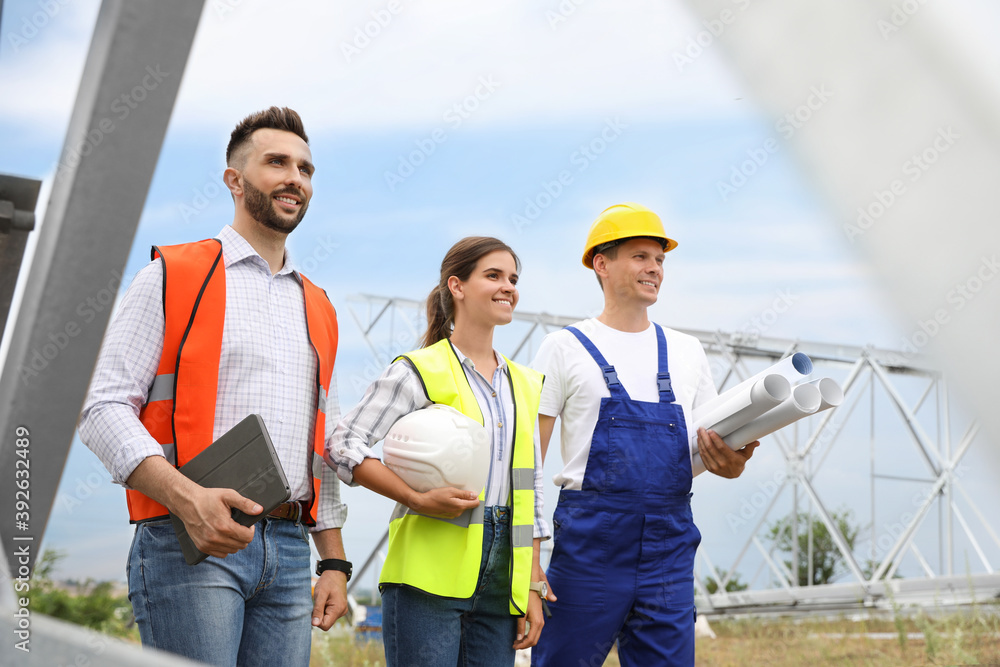Professional engineers working on installation of electrical substation outdoors Professional engineers working on installation of electrical substation outdoors