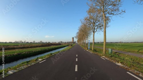 Wallpaper Mural POV driving on dike road with water tower in the background Torontodigital.ca