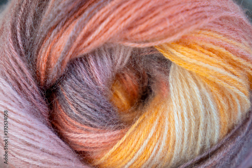 Close-up, grey and multi colored yarns and crochet needle. 