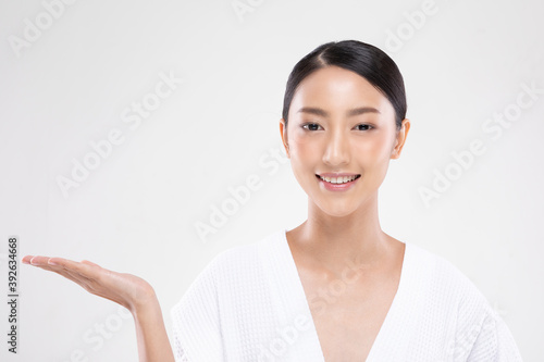 Beautiful Attractive Charming Asian young woman smile with white teeth open hand palm for display cosmetics product cheerful with healthy skin,isolated on white background,Beauty Cosmetics Concept