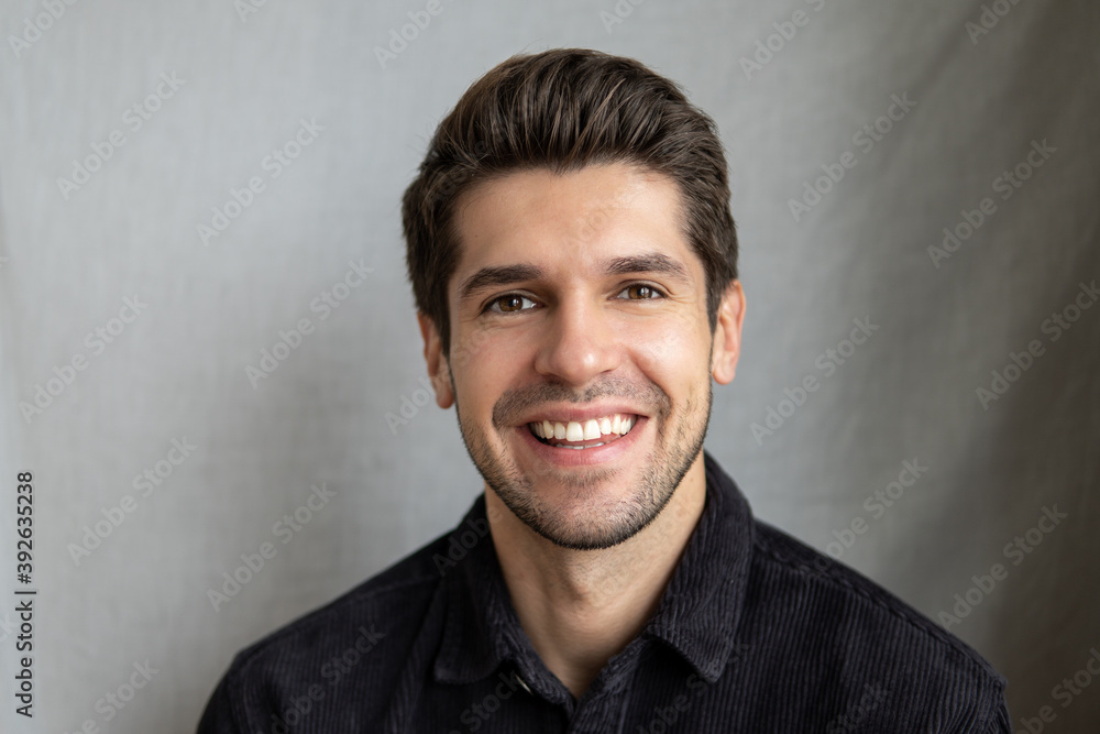 Portrait of a young beautiful man with a wide sparkling smile and perfect teeth Portrait of a young beautiful man with a wide sparkling smile and perfect teeth