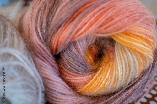 Close-up, grey and multi colored yarns and crochet needle. 