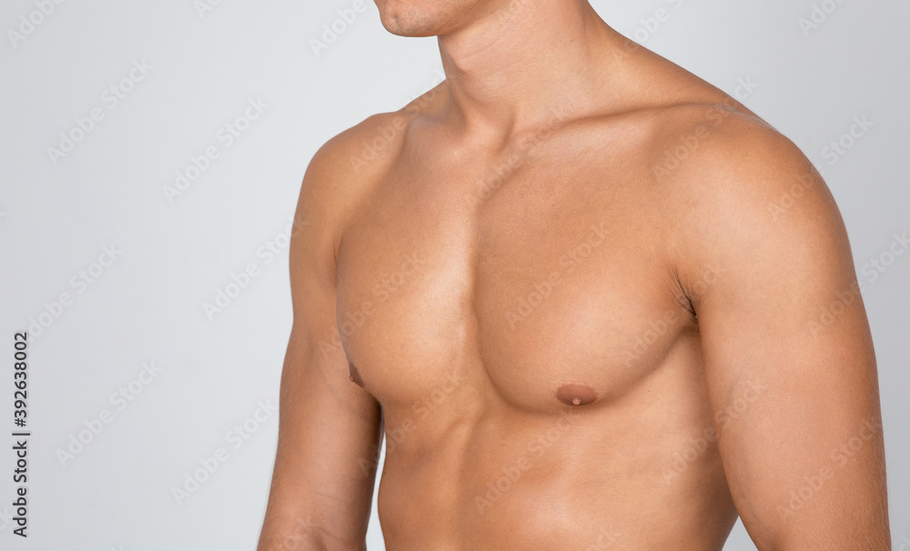Closeup of guy showing his chest at white studio Closeup of guy showing his chest at white studio
