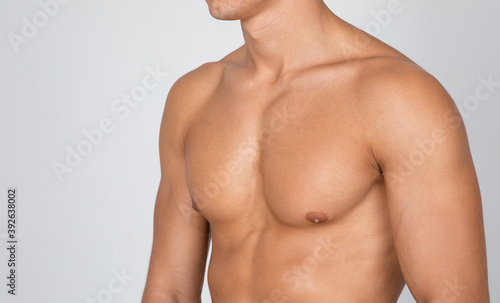 Closeup of guy showing his chest at white studio