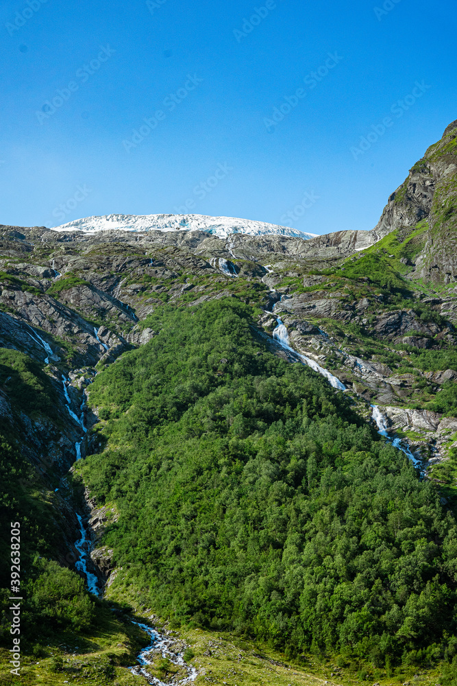 Boeyabreen glacier with forest and waterfalls