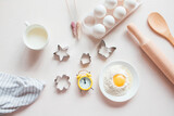 Baking ingredients. Eggs, flour, milk, whisk, rolling pin, bakeware on a white background, top view. cook's workplace in the kitchen. beautiful dishes. Copy space. homemade cookies. Cooking background