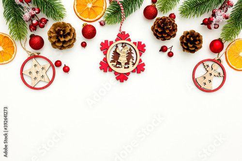 Spruce branch, cones and vintage toys decoration on christmas or new year on white background .