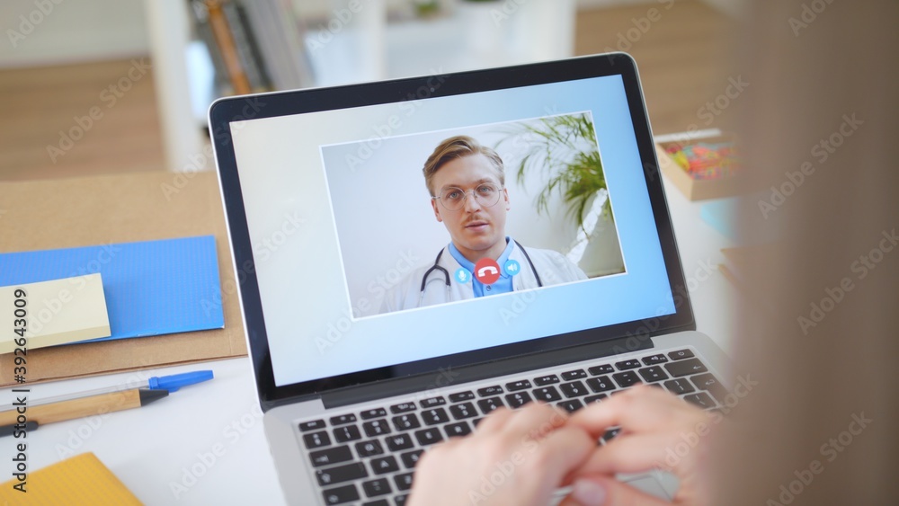 Woman Using Laptop to Talk to His Young Blonde Doctor via Video Conference Medical Person Checks Symptoms Talks with Physician Using Online Video Chat Close-up POV Camera Point of View Woman Using Laptop to Talk to His Young Blonde Doctor via Video Conference Medical Person Checks Symptoms Talks with Physician Using Online Video Chat Close-up POV Camera Point of View
