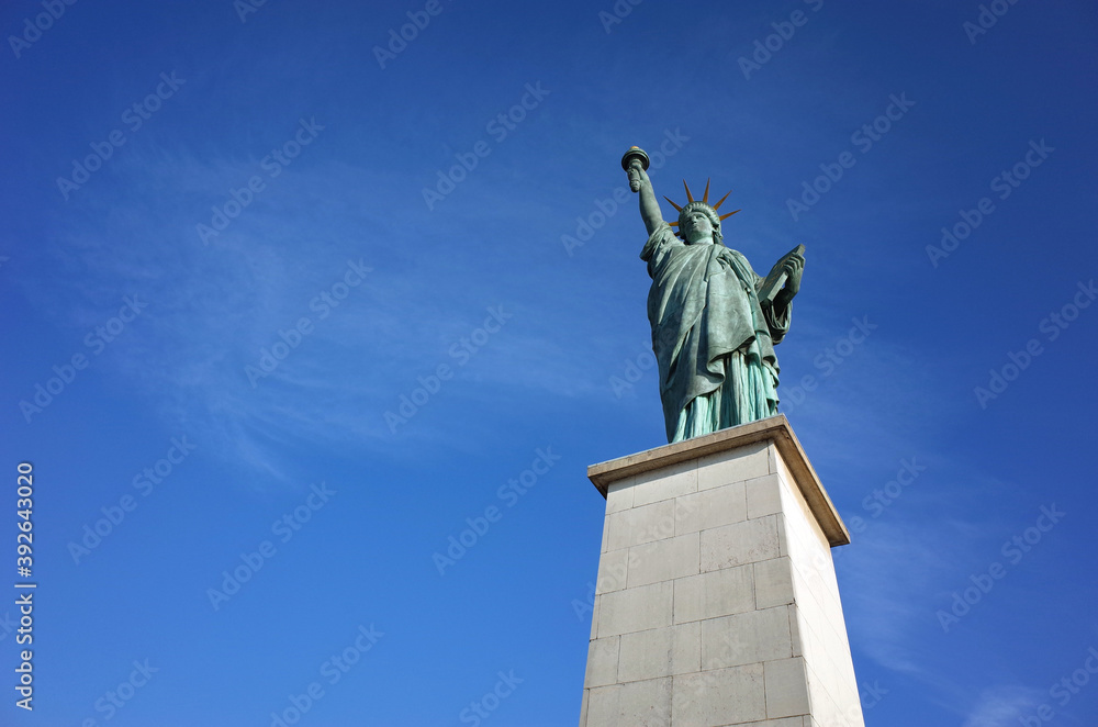 Statue of Liberty in Paris, isolated on background of blue sky