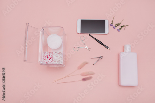 Women's cosmetics. set for manicure. delicate background. beauty concept. means for manicure on a background of flowers. copy space. Gel polishes, nail files, nail scissors, pusher and nippers on top
