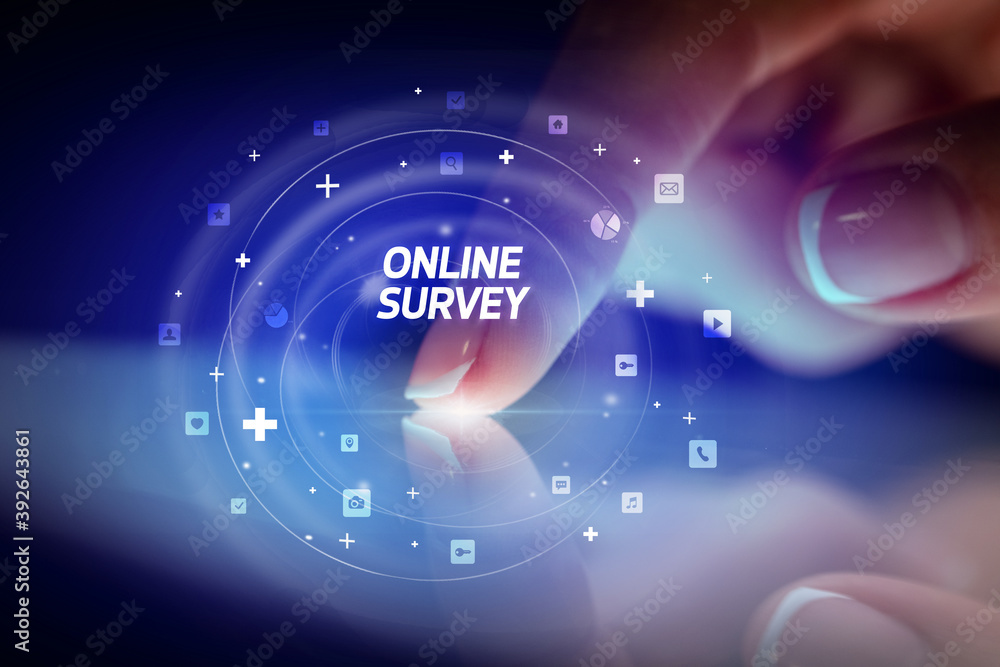 Finger touching tablet with social media icons and ONLINE SURVEY Finger touching tablet with social media icons and ONLINE SURVEY