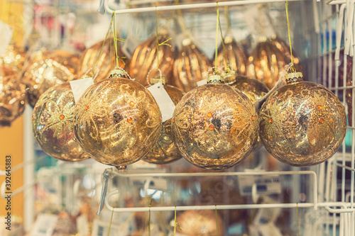 beautiful golden christmas balls on a golden background. Christmas balls close up picture