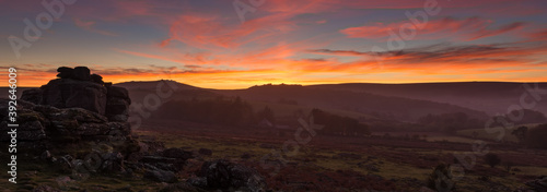A panorama of Hound tor on Dartmoor with a spectacular sunset