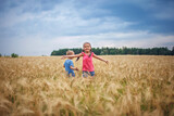 Kids running in wheat field, live life to the fullest, freedom, childhood and happiness
